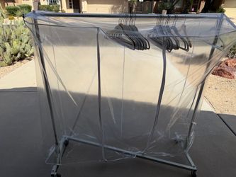 Rolling clothes rack with covet