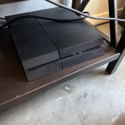 Original PS4 (CUH-1215A), 500GB, includes 2 DualShock 4 controllers, charging dock, and 4 games. Factory reset and ready to go.