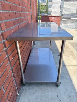 Stainless steel work table with casters 30” x 60”