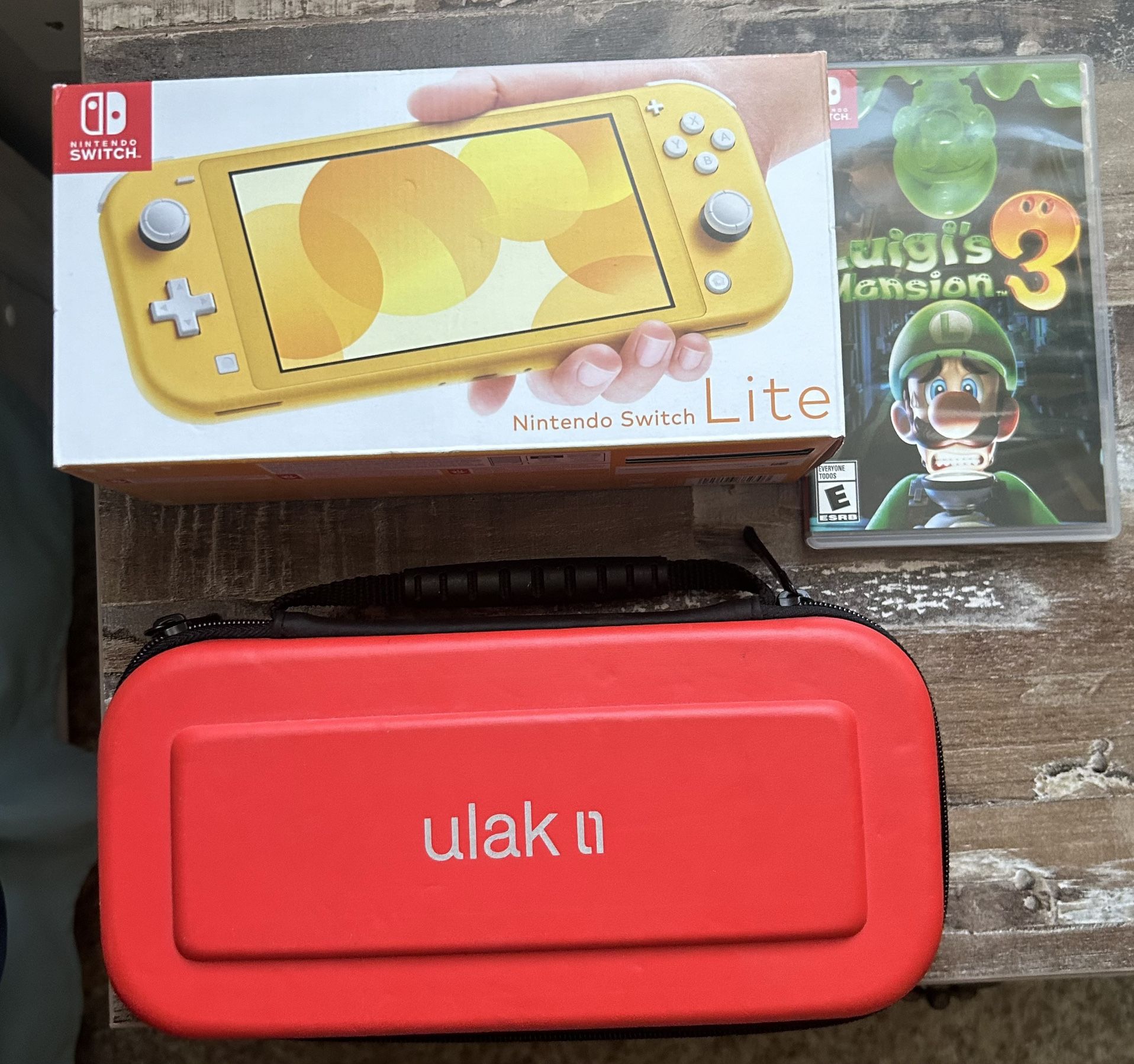 Nintendo Switch Lite, Luigi Mansion 3, and protective case.