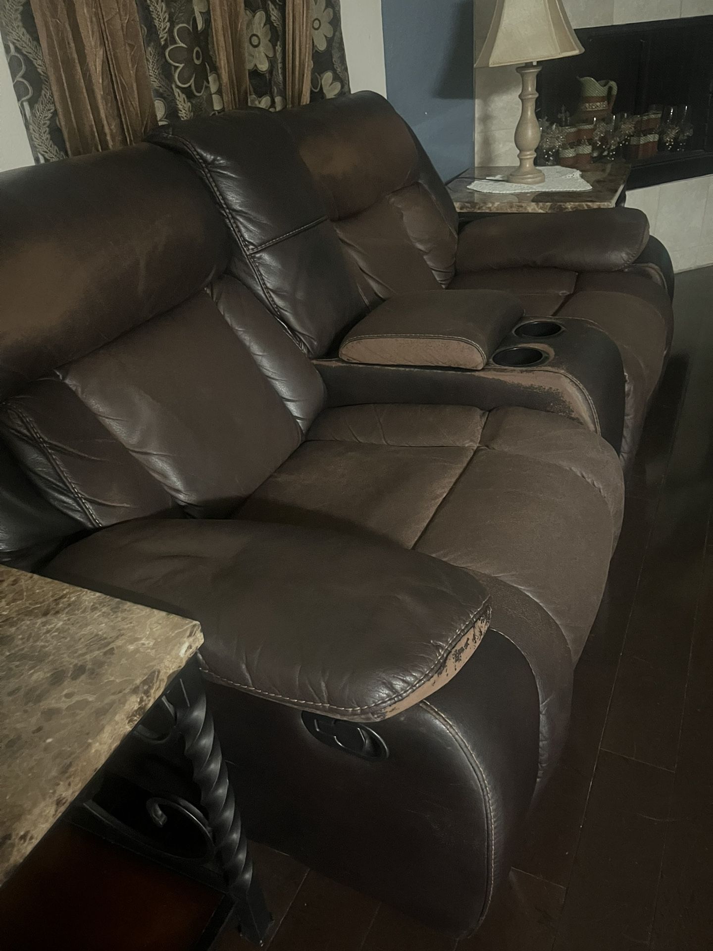 Brown Reclining Couch With Cup Holders And Storage In The Middle.