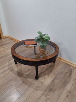 Round glass-top coffee table by Lane Furniture
