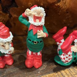 Set of 3 Vintage Christmas Elf Figurines Adorable set of three vintage holiday elf figurines with playful poses and classic Christmas colors