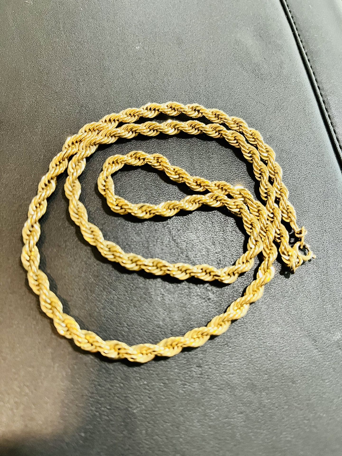 Rope  chain necklace gold tone. On the thicker side of rope chains. Approximately 23 inches in length. As is. No returns. What you see is what you get