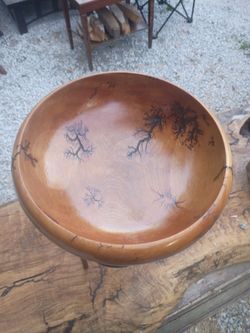 Wooden bowl on black metal stand