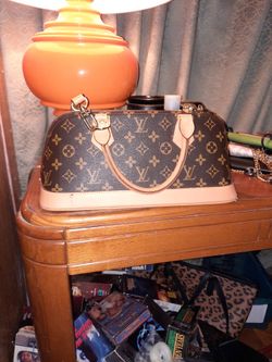 Louis Viltton Hand Bag. Brown With Zipper On Top . Asking 250.00