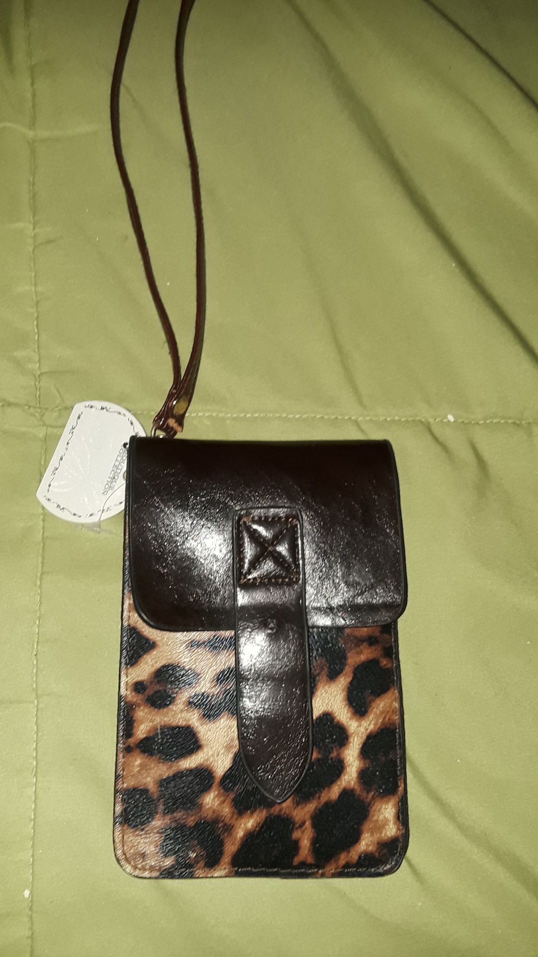 Leather leophard small wrist wallet .