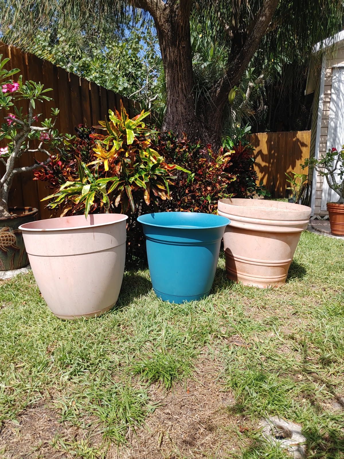 Preowned set of three large plastic flower pots