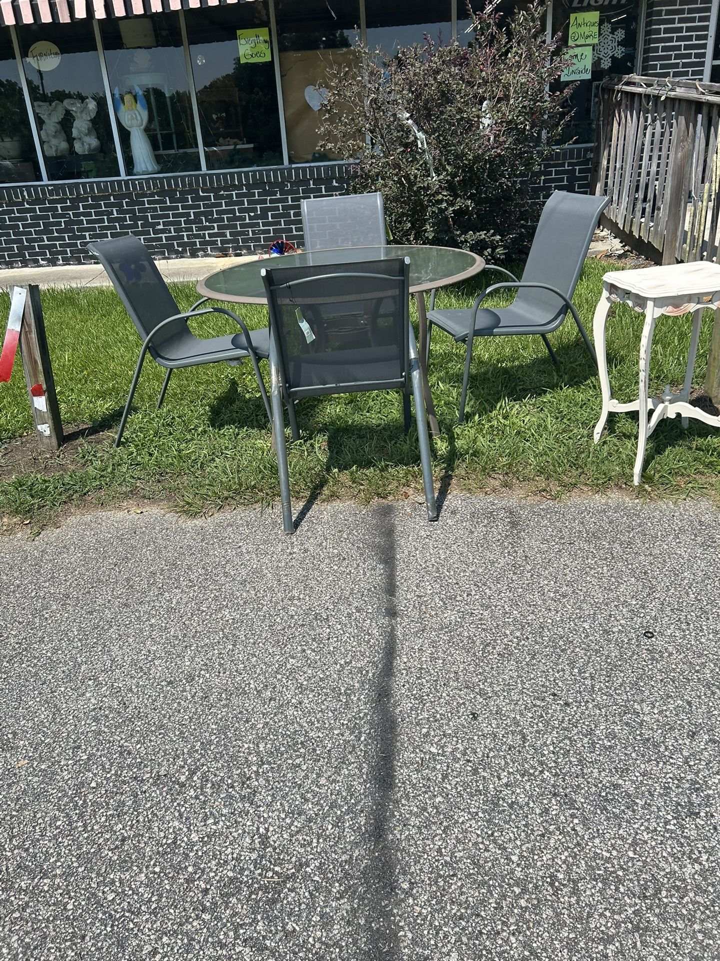 Gray glass patio set with four chairs