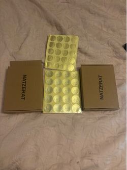 NATZERAT Product Boxes with Gold Seals”.