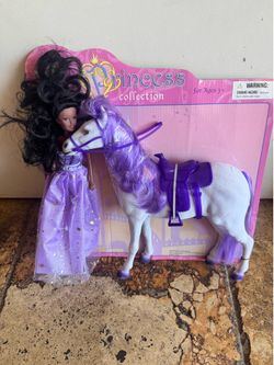 Doll and horse set in vibrant purple. Includes a purple-gowned princess doll and a matching white horse with purple mane, tail, bridle, and saddle. St