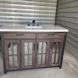 Drysdale 48 in. Wx 34.5 in. H Bath Vanity in Sable with Engineered Stone Vanity Top in Lgt Vein Carrera with White Basin Drysdale 48 in. Wx 34.5 in. H Bath Vanity in Sable with Engineered Stone Vanity Top in Lgt Vein Carrera with White Basin