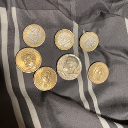 a bunch of coins with a jfk half dollar bill