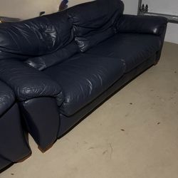 Navy blue leather couch and loveseat