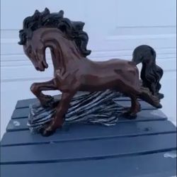 Horse Jumping Over Log Statue
