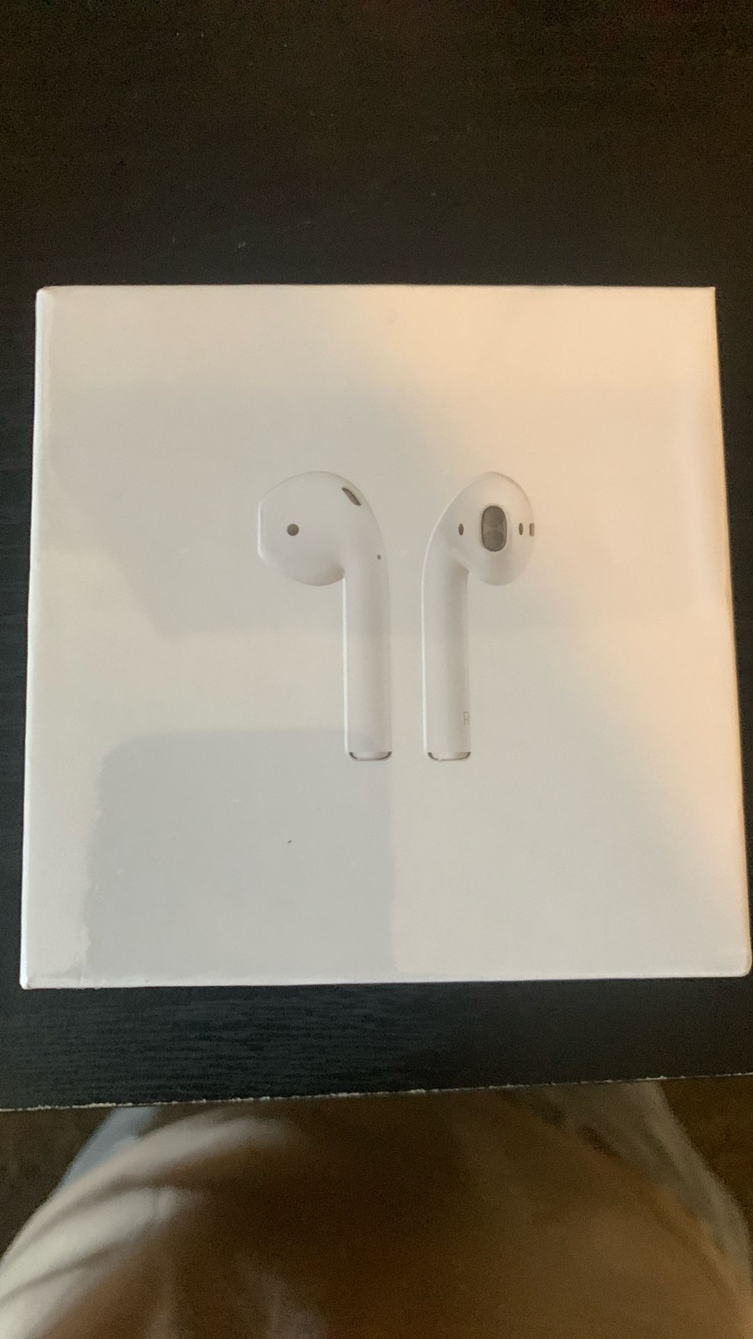 Brand new Apple AirPods (2nd Generation) with a charging case.