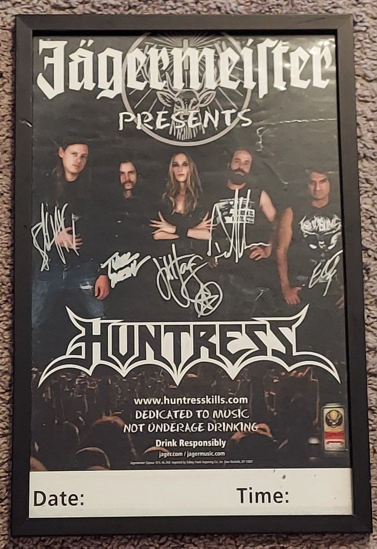 Framed autographed concert poster of Huntress