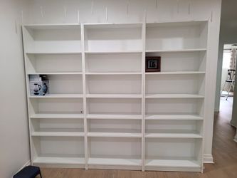 3 white bookshelves