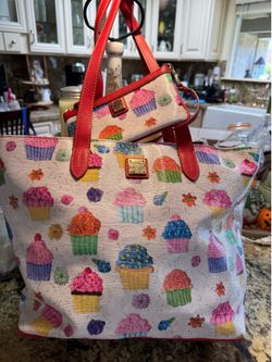 An adorable authentic cupcake Dooney Burke tote with wristlet
