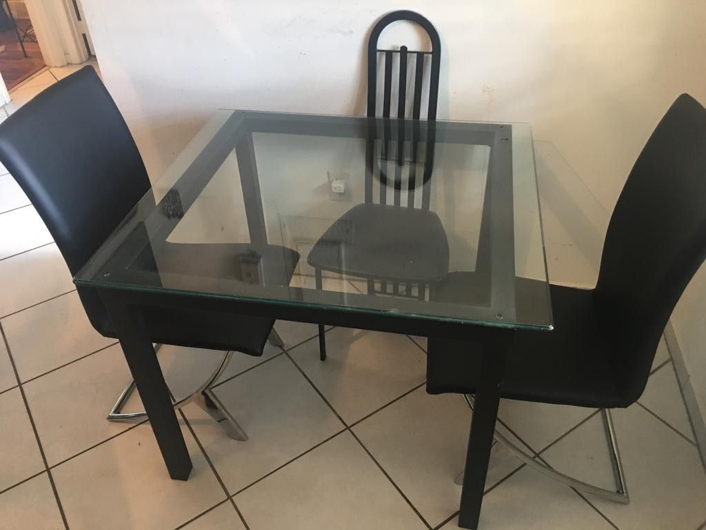 Glass table and 2 black leather chairs