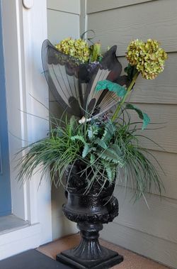 Planter with artificial flower arrangement
