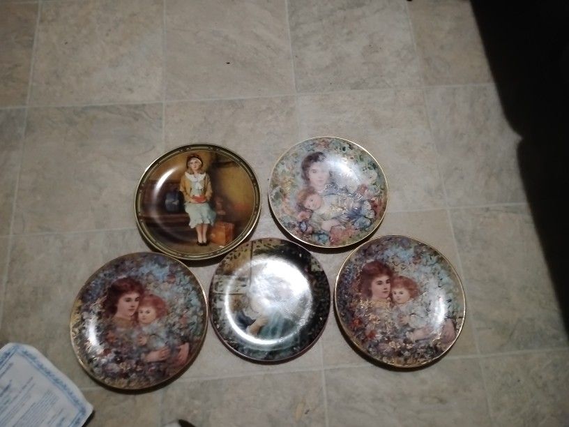 collection of decorative collector plates from the 1989 "The Bonds of Love" series by Brenda Burke. These plates were produced by W.S. George Fine Chi
