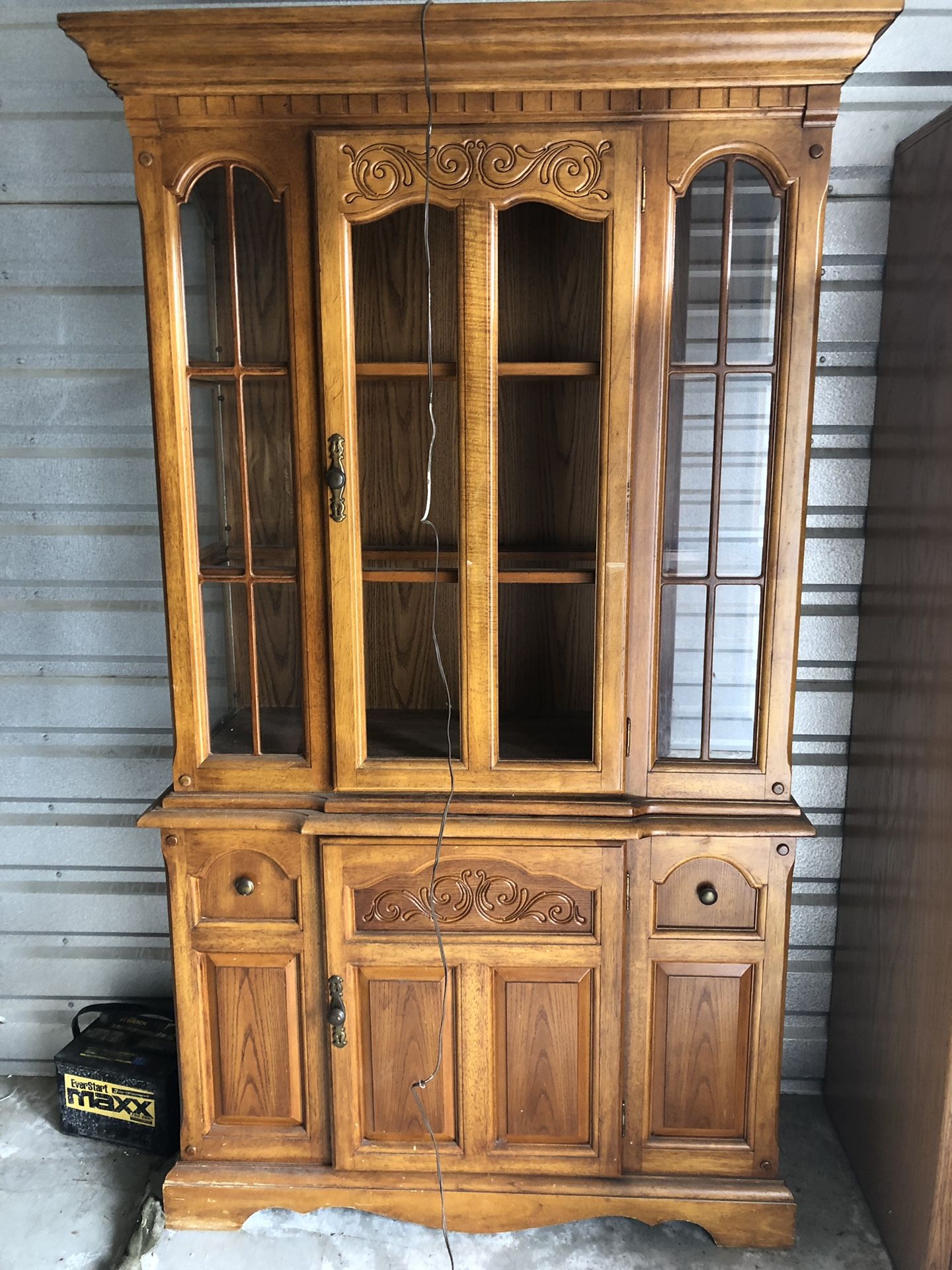 Wooden China cabinet w/ integrated light fixture.