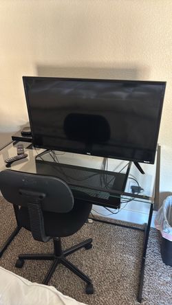 TV and desk and DVD player and chair