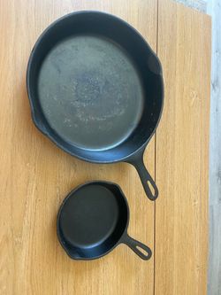 Small and large cast iron skillets