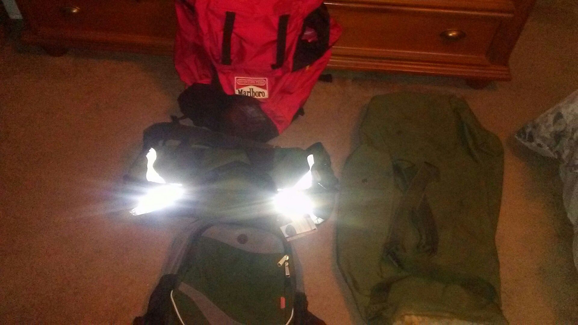 One extra large Marlboro backpack , one green backpack, one green athletic bag, large army duffle bag .