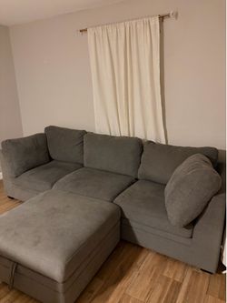Grey Couch with a storage ottoman