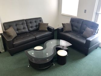 New black sofa & loveseat with coffee table & 2 ottomans
