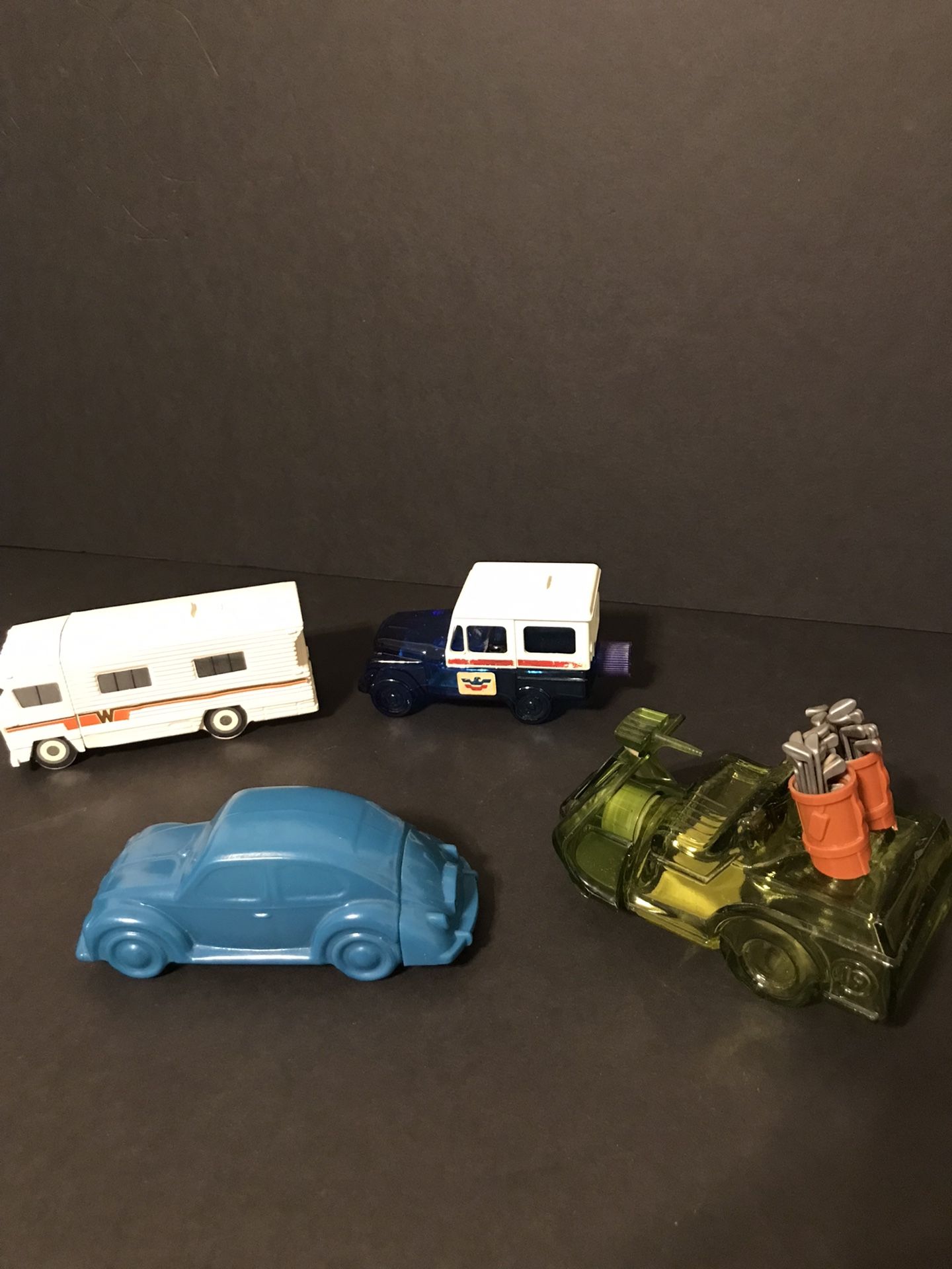 Set of 4 Vintage Avon Vehicles- VW Bug, Winnebago RV, Mail Truck, & Golf Cart