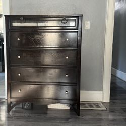 5 Drawer Black Wood Chest With Frosted Top Drawer And Curved Bottom 