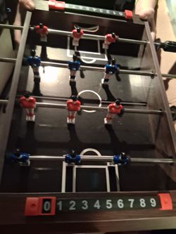 Mini fooseball table with 2 balls already put together