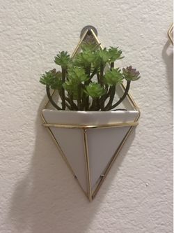 A pair of small plant hanging planters