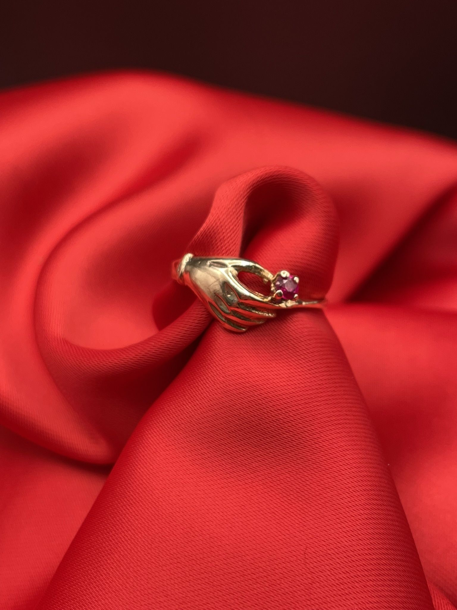 14k Gold Ring Hand Holding A Ruby Stone-July Birthstone