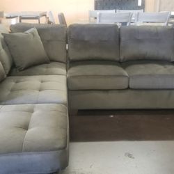 Chocolate reversible sectional with a matching ottoman