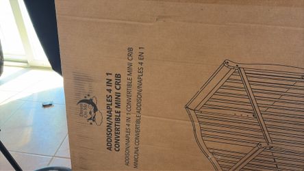 White mini crib and mattress