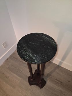 Green marble and wood podium