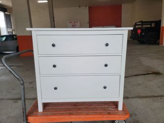 IKEA HEMNES 3 drawer bedroom chest in a whitebstained finish, featuring distinctive dark round knobs on each drawer. 42 1/2" W x 37 3/4" H.