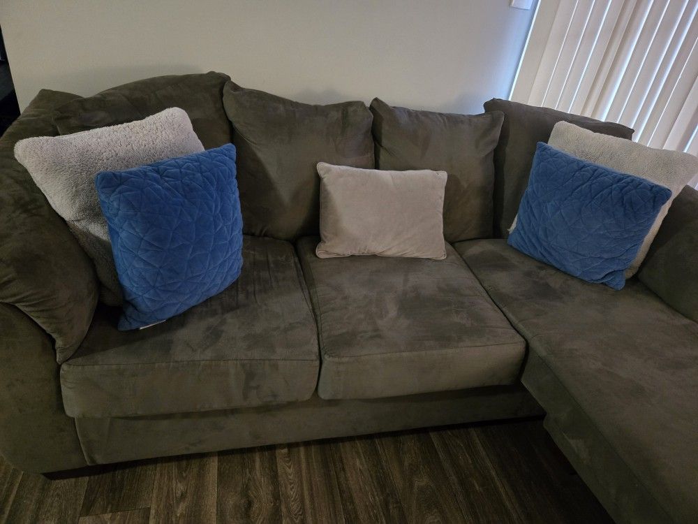 Grey Couch  Two  Blue Pillows  Two Grey Pillows 