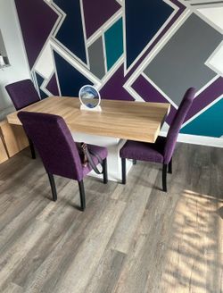 Table and chairs, three purple chairs and a medium size table