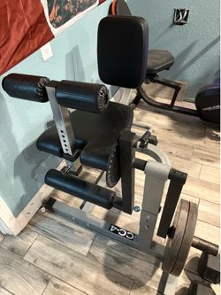 Plate loaded leg extensions and leg curl machine