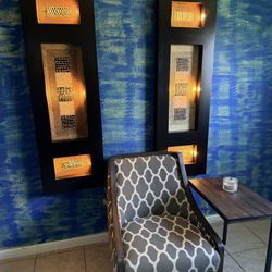 pair of decorative wood wall art panels featuring abstract, textured inserts.