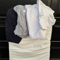 Crib mattress with sheets and protector