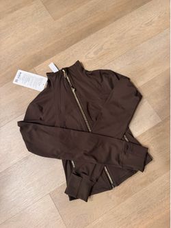 Brown and white Lululemon define cropped jackets