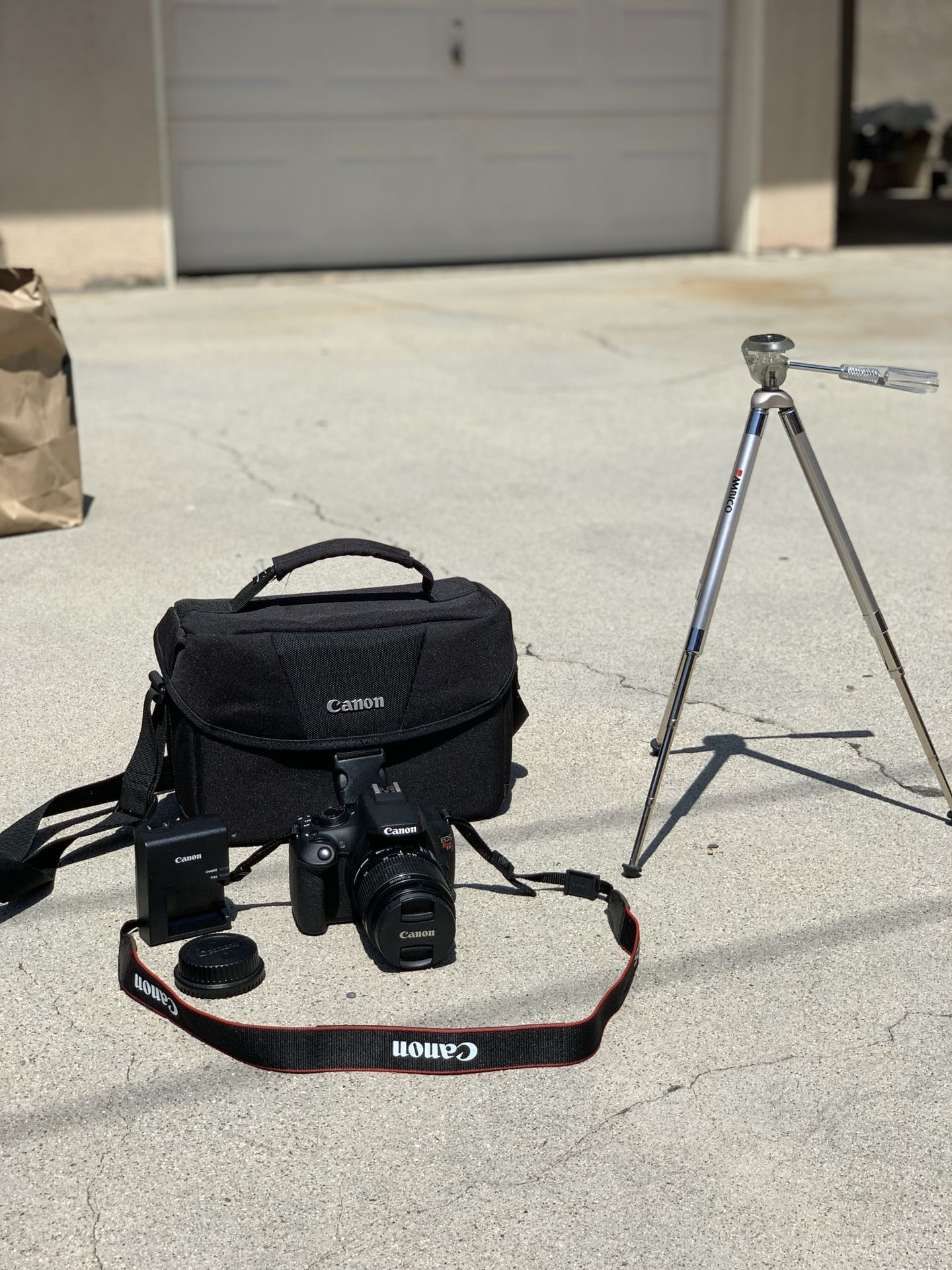 Cannon Rebel t5 camera with lens, battery, charger, bag, tripod, and lens protection