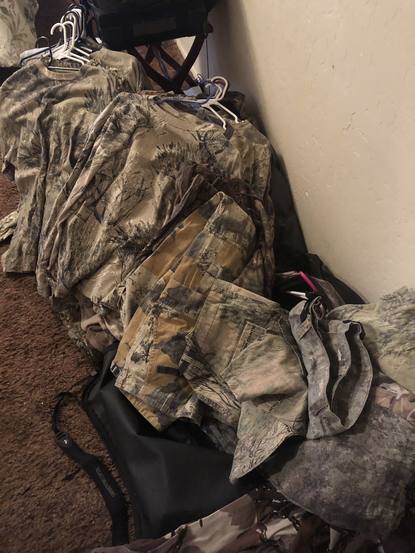 Camouflage hunting clothes and large Rocky duffle bag mostly Cabelas brand on clothes