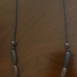 beaded necklace made of dark wood and coconut beads